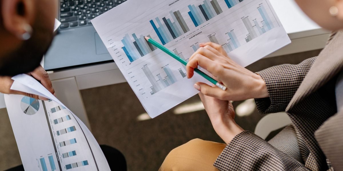 A business team reviewing data and charts, symbolizing strategic planning amidst AI growth.