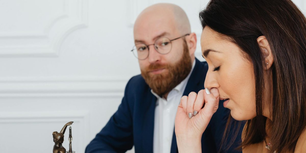 A professional looking concerned, symbolizing the stress of potential audit failures and non-compliance.