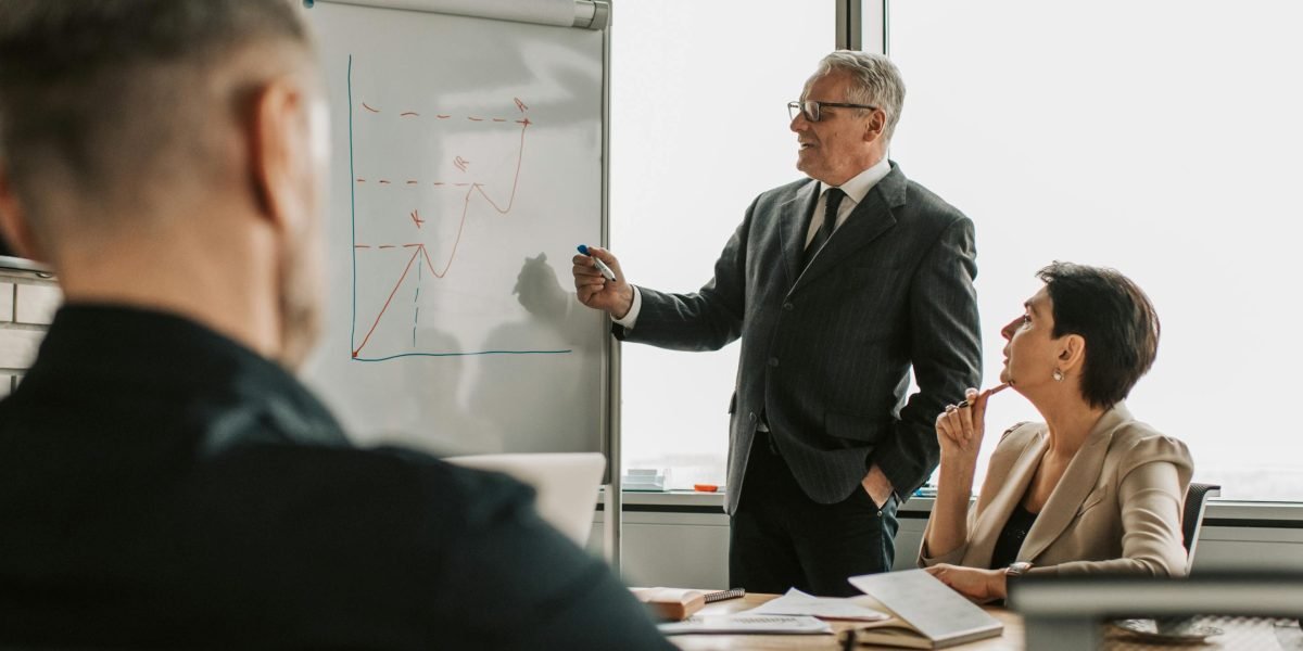 A cybersecurity consultant explaining AI safety measures to a team, highlighting the importance of building robust systems.