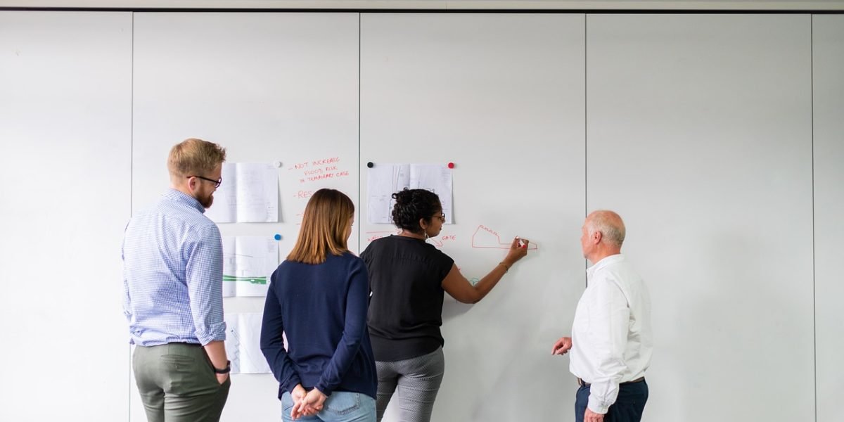 A team collaborating to understand and mitigate complex AI risks and architectural vulnerabilities in a professional setting.