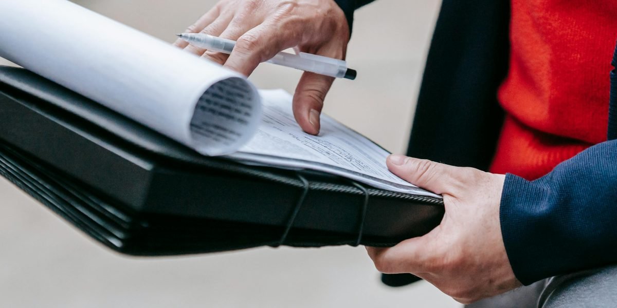 A person carefully reviewing documents, symbolizing the need for critical evaluation of AI outputs in business.