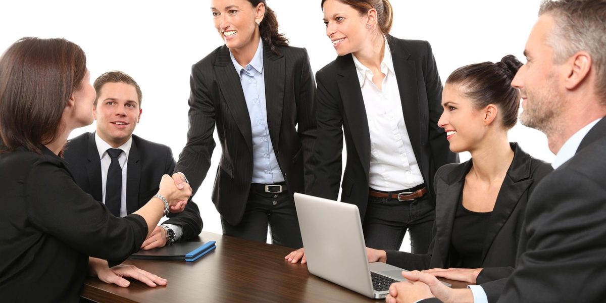 A team in a meeting discusses potential business risks and impacts of AI-generated misinformation.