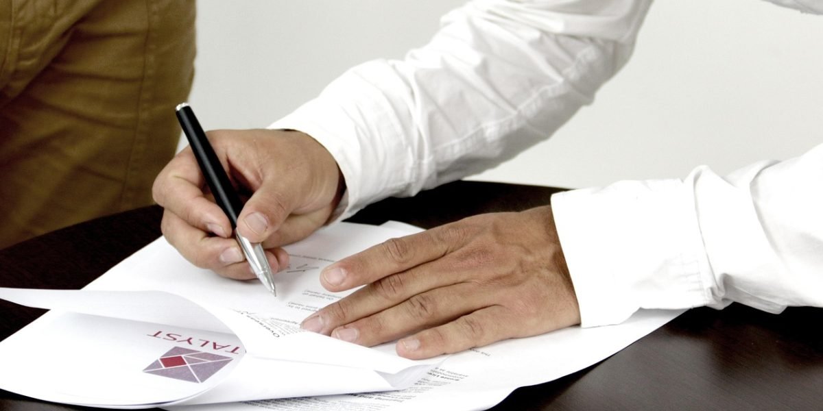 A person intently studying a document, symbolizing critical review and attention to detail.
