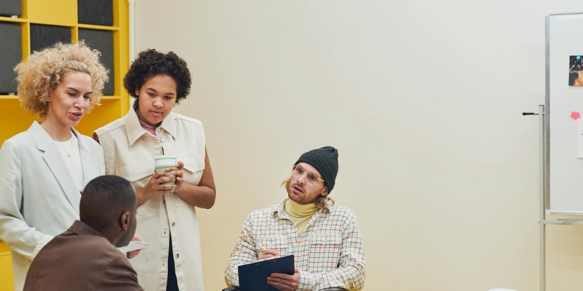 Team members discuss challenges and brainstorm solutions in a modern office setting.