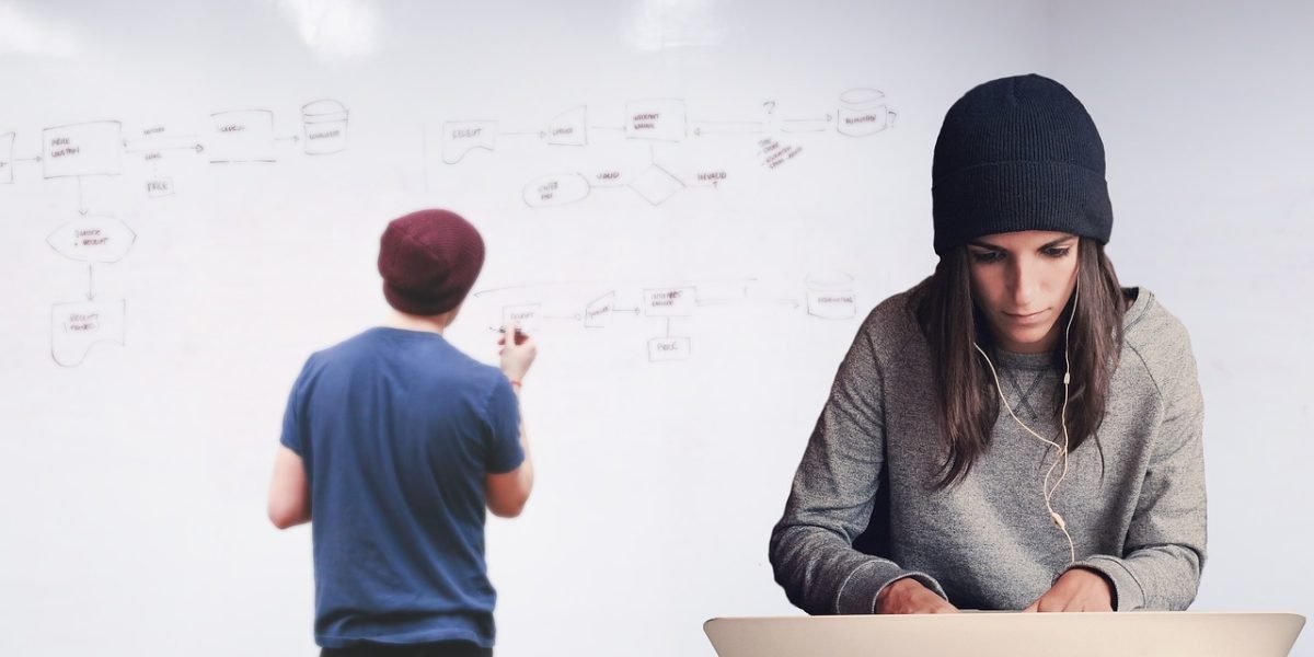 A team collaborates around a whiteboard, mapping out data pipelines and testing strategies.