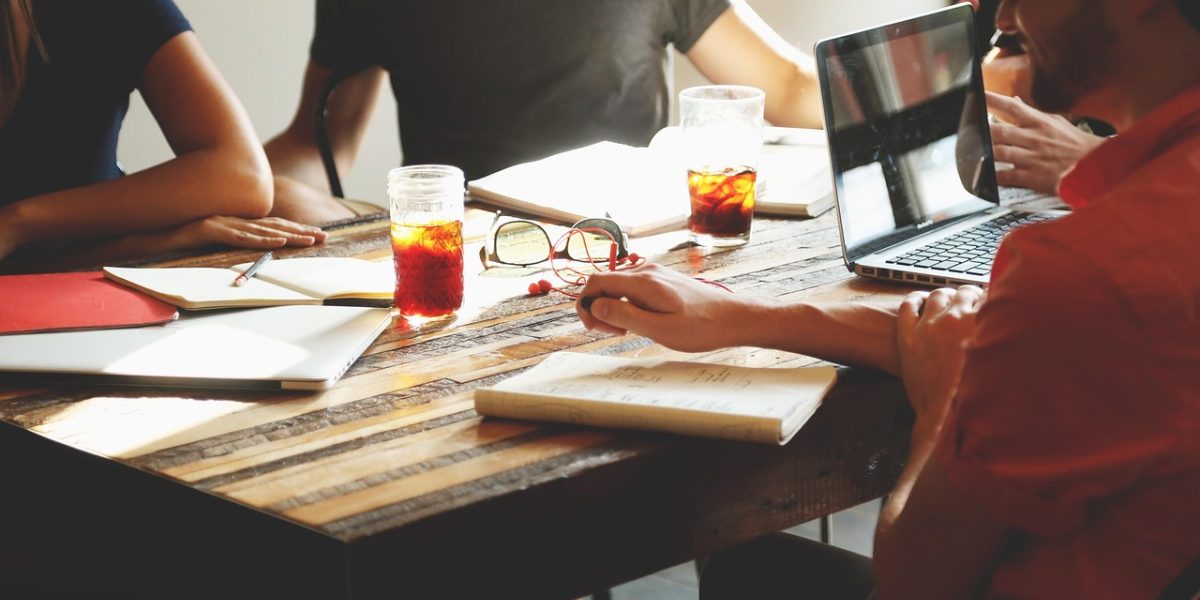 A professional leads a project meeting, presenting findings from AI testing plans to a team.