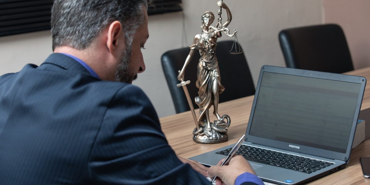 A lawyer meticulously reviewing legal documents, emphasizing the need for accuracy in legal AI applications.