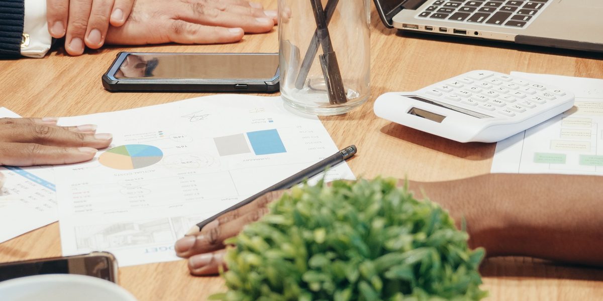 A business team diligently analyzing financial reports, symbolizing the hidden monetary costs of AI errors.