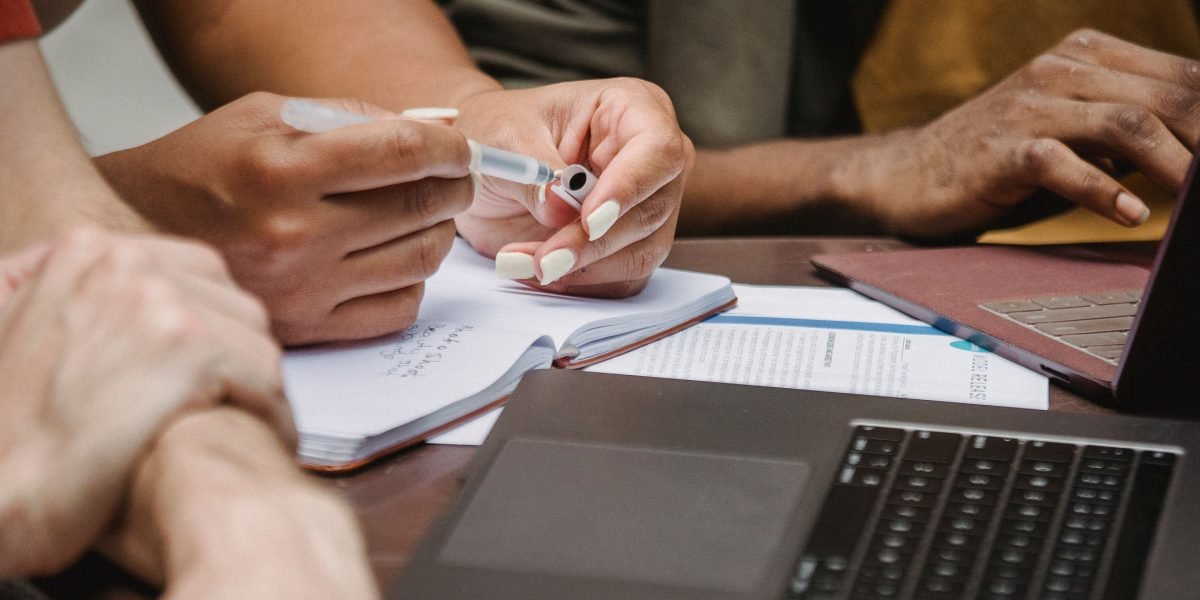 A team of researchers collaborates around a table, symbolizing enhanced productivity and focus on core ideas with AI assistance.