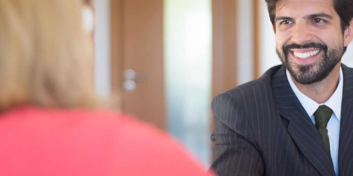 A professional sits confidently during a job interview, demonstrating strong communication and problem-solving skills.
