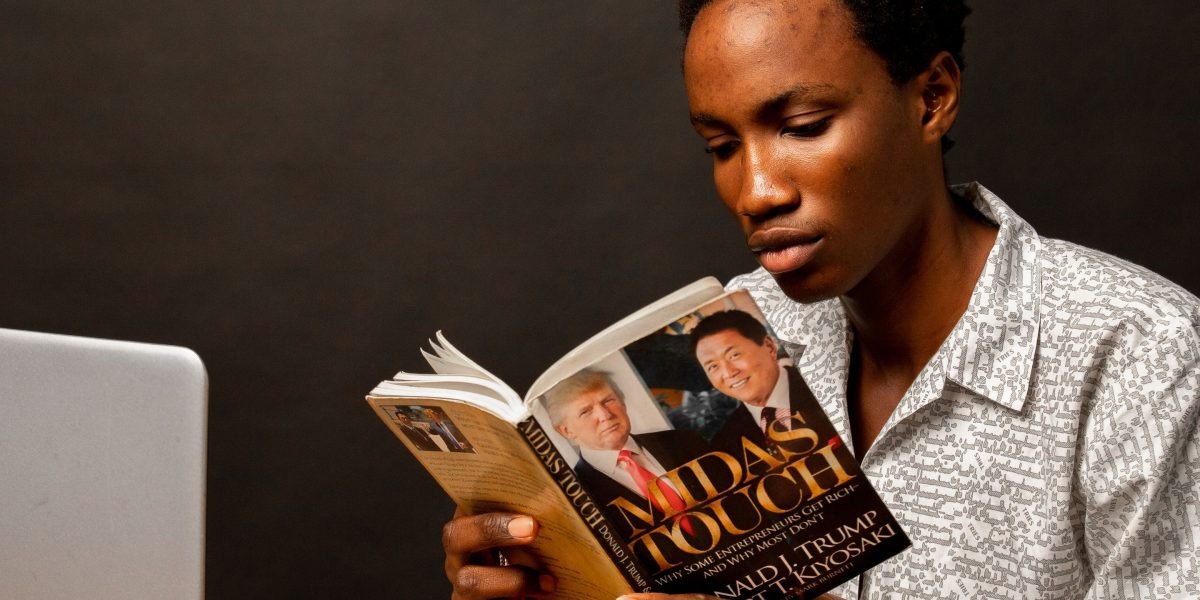 An individual is deeply focused on reading, symbolizing continuous learning and professional development in a dynamic field.