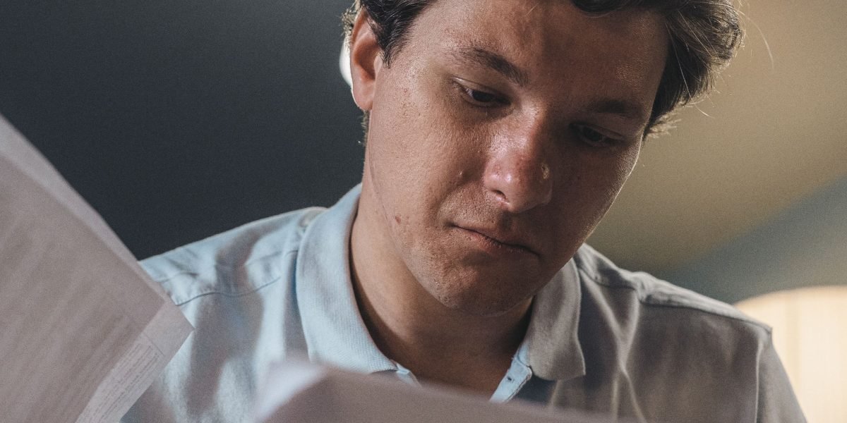 A person carefully reviewing content on a screen, looking for potential inaccuracies.