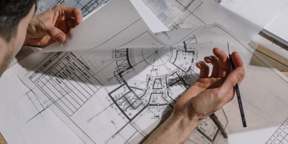 A professional reviews complex security architecture plans, symbolizing the strategic thinking required for the role.