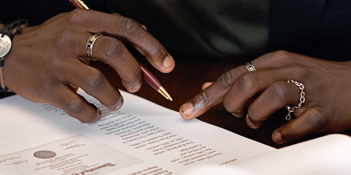 A person carefully examining a contract, emphasizing the importance of thorough vetting before committing to an SEO agency.