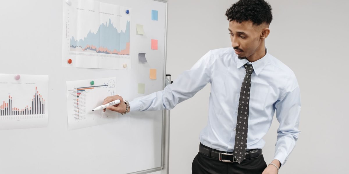 A professional explaining a complex system on a whiteboard, representing the innovative Value Reinforcement System (VRS).