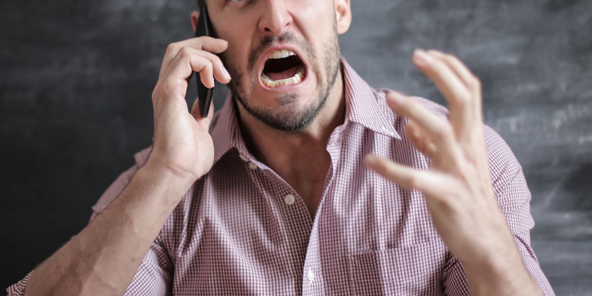 A frustrated customer consulting a map on their phone, depicting the consequence of inaccurate business information from AI hallucinations.