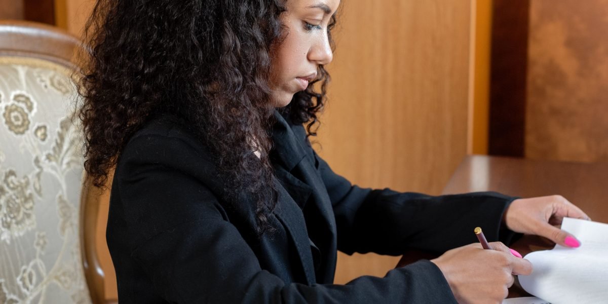 A person diligently reviewing documents, symbolizing the critical human oversight needed to prevent AI hallucinations.