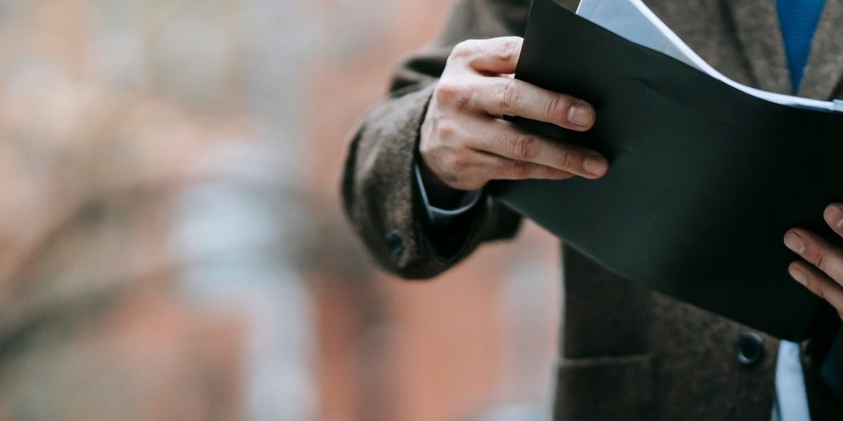 A professional reviewing complex compliance documents, emphasizing the importance of data governance.