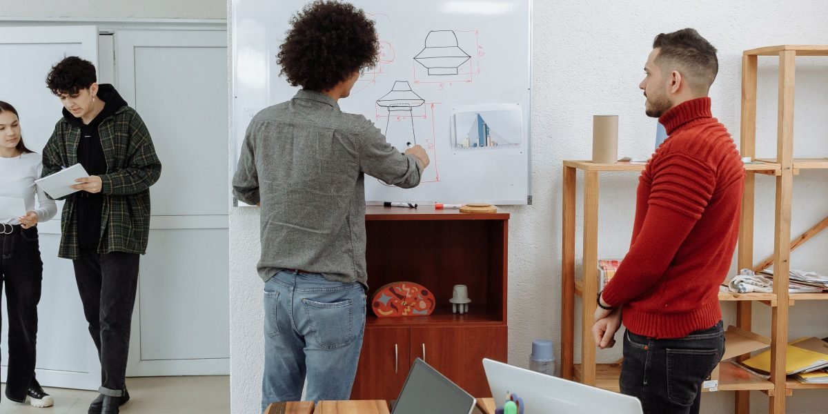 A diverse team engages in a planning session, using a whiteboard to map out scalable workflows for research and AI integration.