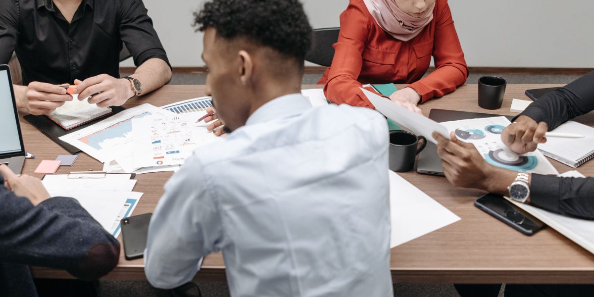 A diverse team actively collaborating and sharing ideas in a modern meeting room setting.